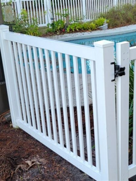 The same pool fence gate after cleaning, bright white