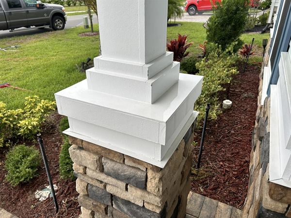 The same porch column base after cleaning, clean white trim