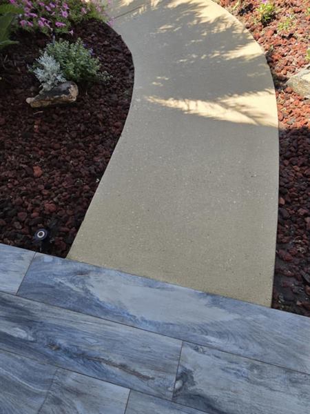 Curved concrete walkway after pressure washing, St. Augustine