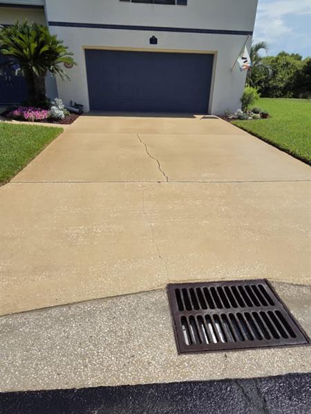 Concrete driveway before cleaning, stained yellow and grey