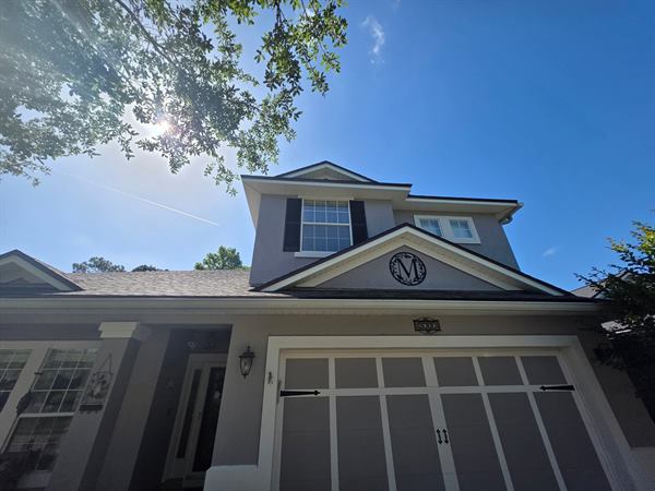 Two-story grey stucco house after a full exterior wash, St. Augustine