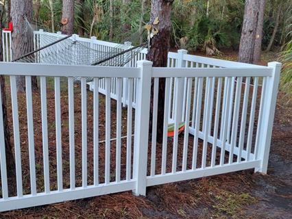 White vinyl pool fence and gate after cleaning