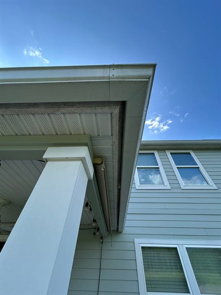 Clean white porch column, soffit and siding under a blue sky