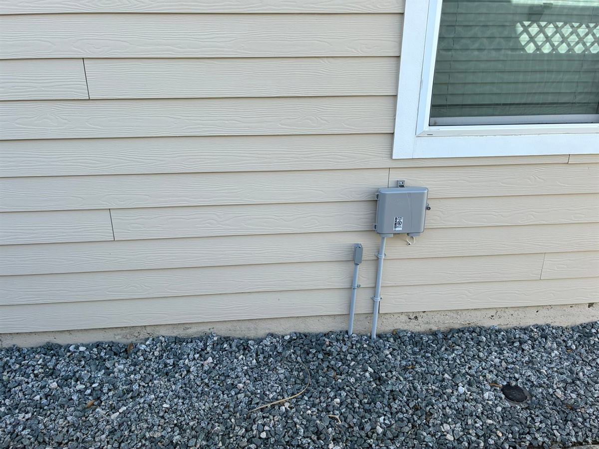 The same tan siding after cleaning, the mildew line gone, St. Augustine